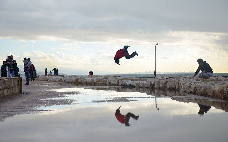 Parkour in Jbeil on the Corniche with onlookers and Beirut in the background.jpg
